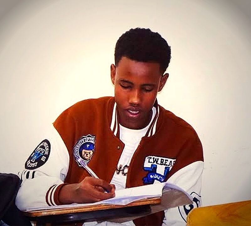 Atlas College student focused on course materials in a collegiate academic setting